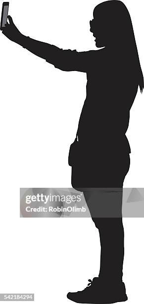 girl taking selfie silhouette - camera stand stock illustrations