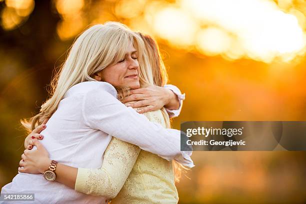 affectionate moment - mature woman daughter stock pictures, royalty-free photos & images