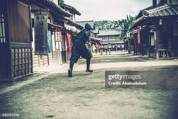 ninja chasing japanese women in kimono and traders, edo period - ninja stock pictures, royalty-free photos & images