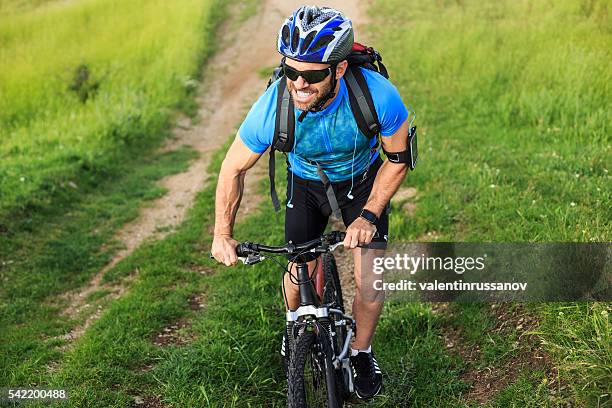 mountainbiker climbing the mountain - bike headset stock pictures, royalty-free photos & images