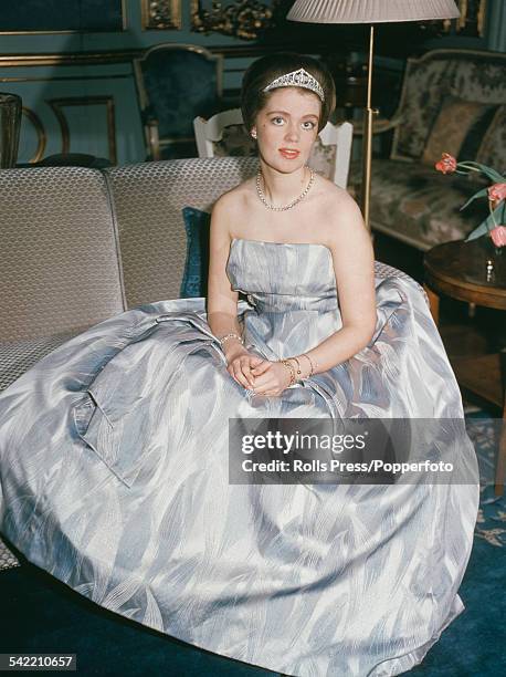 Portrait of Princess Birgitta of Sweden pictured wearing a tiara and ballgown whilst sitting on a couch circa 1960.