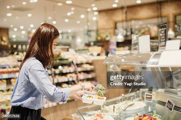 young woman buying grocery in supermarket - side dish stock pictures, royalty-free photos & images