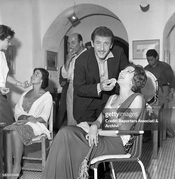 Italian singer Mina and Italian songwriter Domenico Modugno during a break on the set of Appuntamento a Ischia. 1960