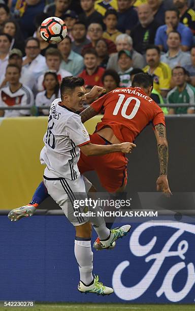 Chile's Pedro Hernandez and Colombia's Daniel Torres jump for a header during the Copa America Centenario semifinal football match in Chicago,...