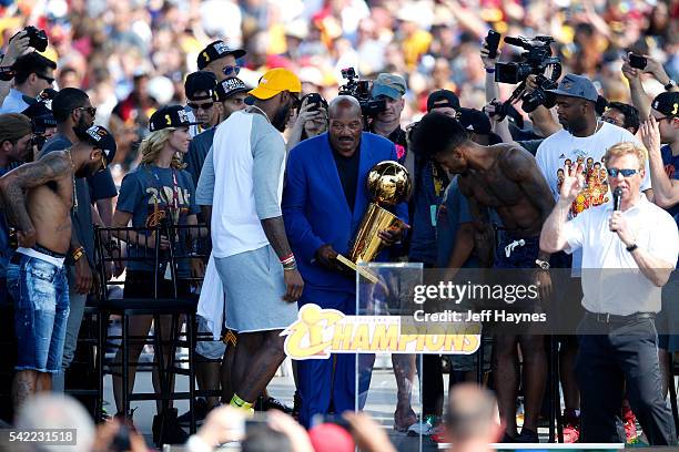 Jim Brown hands the Larry O'Brian NBA Championship trophy to LeBron James of the Cleveland Cavaliers during the Cleveland Cavaliers Victory Parade...