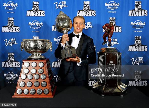 Patrick Kane of the Chicago Blackhawks poses after winning the Hart Trophy, the Ted Lindsay Award and the Art Ross during the 2016 NHL Awards at The...