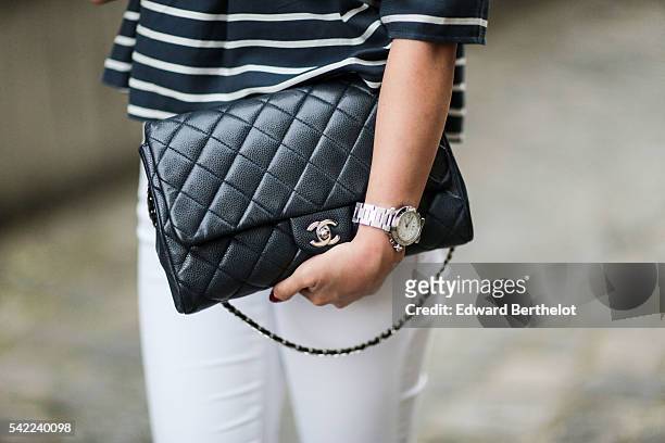 May Berthelot , is wearing a Topshop striped top, white jeans, Asos sandals, and a Chanel blue caviar bag, in the street of Paris, during Paris...