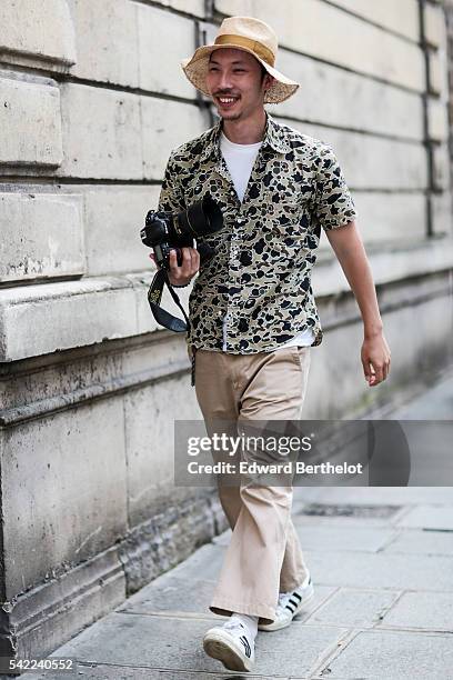 Photographer is wearing a white hat, after the Valentino show, during Paris Fashion Week Menswear Spring/Summer 2017, on June 22, 2016 in Paris,...