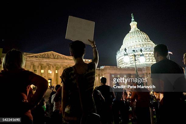 Supporters of House Democrats taking part in a sit-in on the House Chamber shout encouragement from outside the U.S. Capitol on June 22, 2016 in...