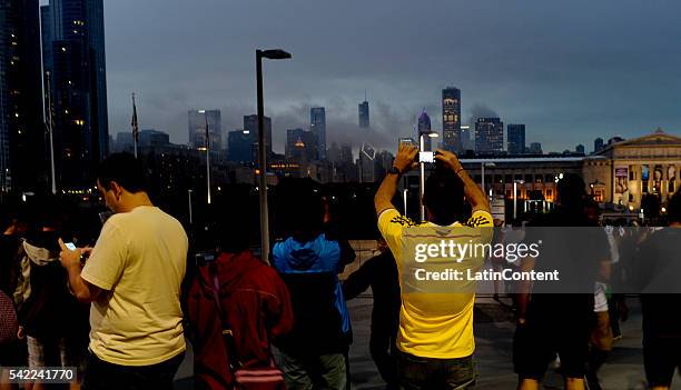 Fans take photos of the Chicago skyline as rain delayed the second half of a Semifinal match between Colombia and Chile at Soldier Field as part of...