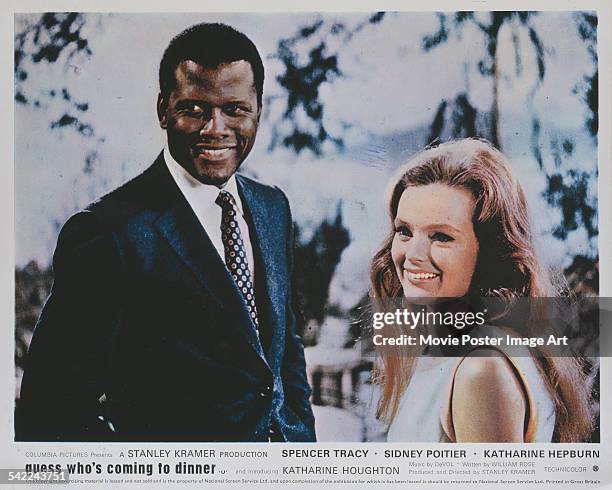 Actors Sidney Poitier and Katharine Houghton appear on the poster for the Columbia Pictures film 'Guess Who's Coming To Dinner', 1967.