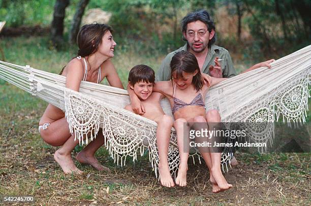British singer and actress Jane Birkin and French singer and composer Serge Gainsbourg with their daughter Charlotte and Birkin's daughter Kate Barry...