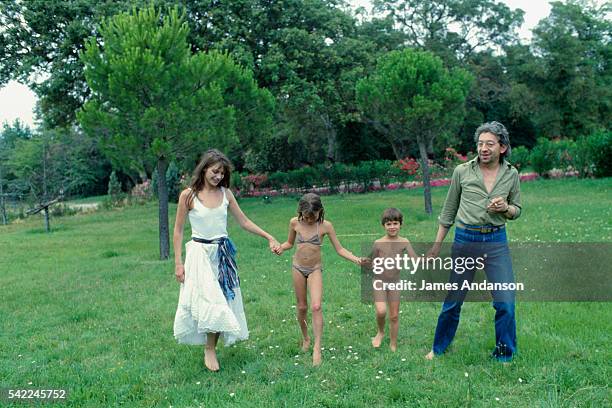 British singer and actress Jane Birkin and French singer and composer Serge Gainsbourg with their daughter Charlotte and Birkin's daughter Kate Barry...