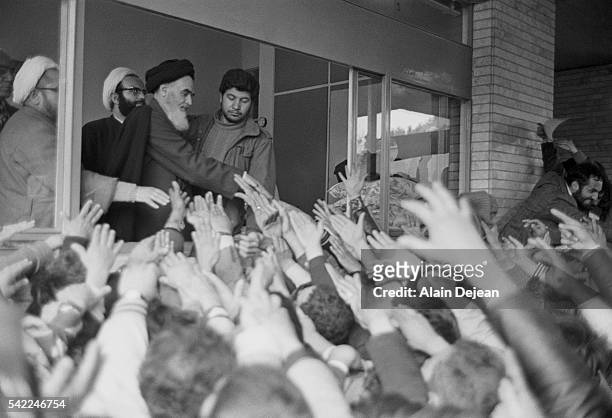 Ayatollah Ruhollah Khomeini greets the crowd at Tehran University after his return to Iran from exile in France during the Iranian Revolution.