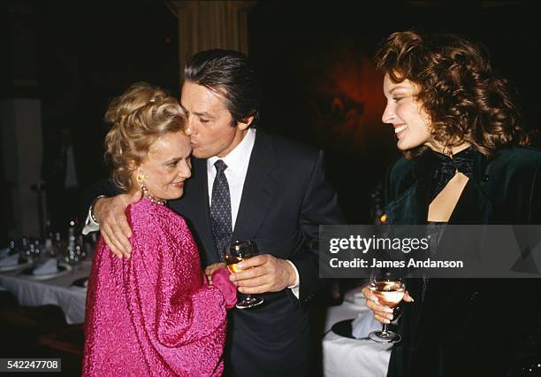 French actress Jeanne Moreau is congratulated by Alain Delon and Valerie Kaprisky after the premiere of the play "Le Recit de la Servante Zerline".