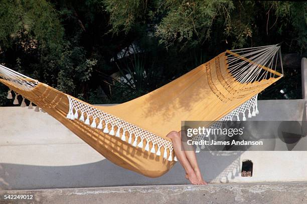 French actress Brigitte Bardot in a hammock at her home in St.-Tropez, La Madrague.