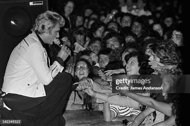 French singer Sylvie Vartan and her husband, the French rock singer Johnny Hallyday perform at an exceptional concert at the Palais des Sports in...