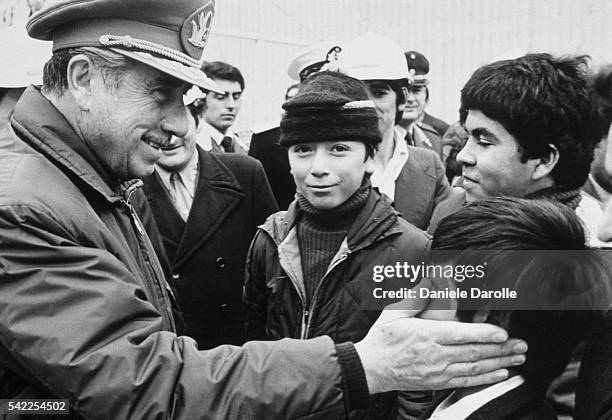 Chile's General Augusto Pinochet greets compatriots in the streets of Santiago.