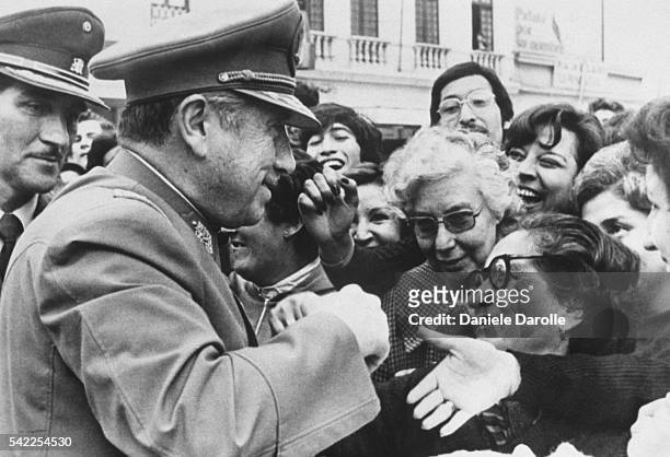 Chile's General Augusto Pinochet greets compatriots in the streets of Santiago.