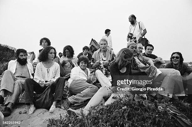 William S. Burroughs, Brion Gysin, and John Giorno surrounded by friends on the seashore of Castel Porziano during the Festival Internazionale dei...