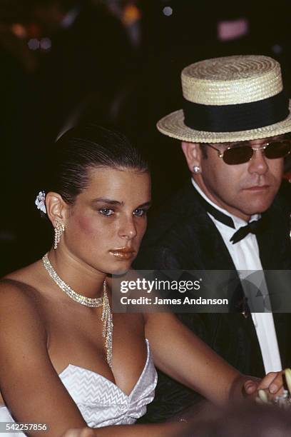 Princess Stephanie of Monaco at the dinner table with the British singer Elton John during the 1984 Monaco Red Cross ball.