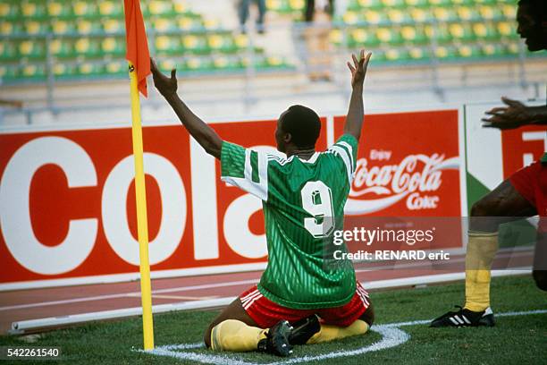 Roger Milla celebrates scoring a goal during a first round match of the 1990 FIFA World Cup against Romania. Cameroon won 2-1.