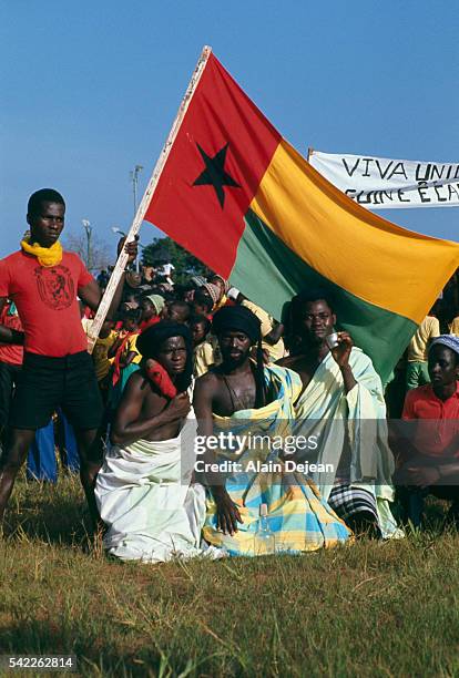 Demonstrators celebrate the independence of Guinea-Bissau from Portugese rule during public demonstrations organized by the PAIGC .