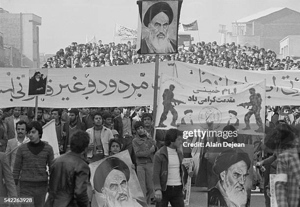 Demonstrators in Tehran carry photographs of Ayatollah Khomeini and banners showing support for the provisional goverment of Prime Minister Medhi...