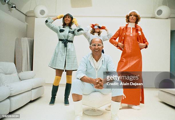Fashion designer André Courrèges poses with models during his 1972 fashion collection presentation.