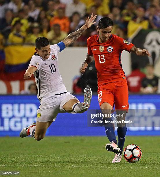 James Rodriguez of Colombia leaps to try and block a pass by Erick Pulgar of Chile during a semi-final match in the 2016 Copa America Centernario at...