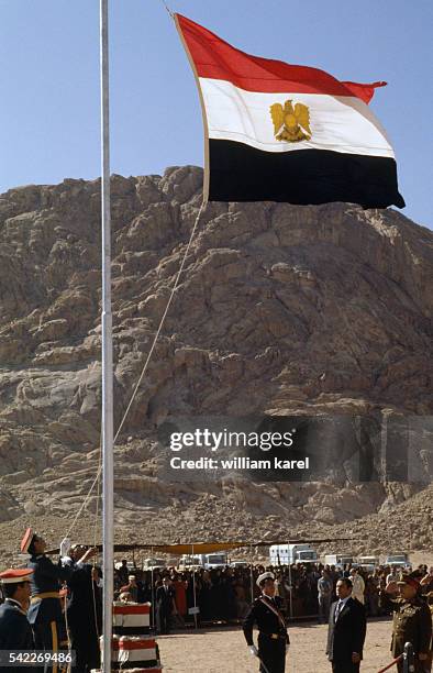 Egyptian President Anwar al-Sadat raises the Egyptian flag near St. Catherine's Monastery at the foot of Mount Sinai, part of which was recently...