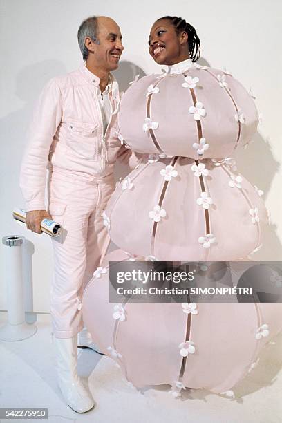 French fashion designer André Courrèges presents his 1976 collection with one of his models.