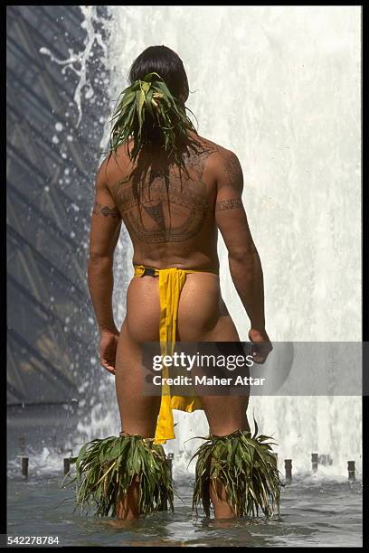 The Polynesian dancers' dress shows up their muscles and their tattoos.