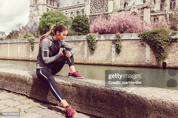 sports woman checking pulse on smart watch - paris sport stock pictures, royalty-free photos & images