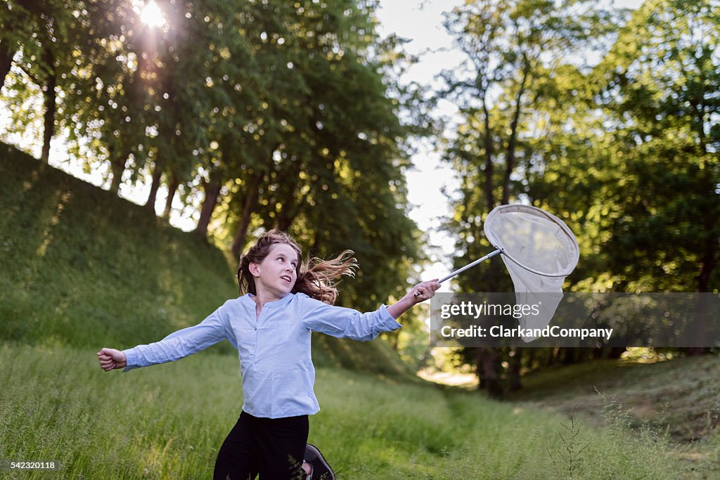 Young Girl Running With a Butterfly Net.