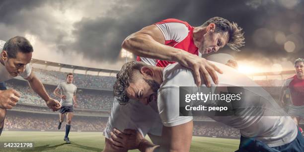 close up of rugby player tackled hard during match - rugby tackle stockfoto's en -beelden