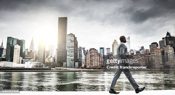 successful business man looking away against the skyline - new york trip stock pictures, royalty-free photos & images
