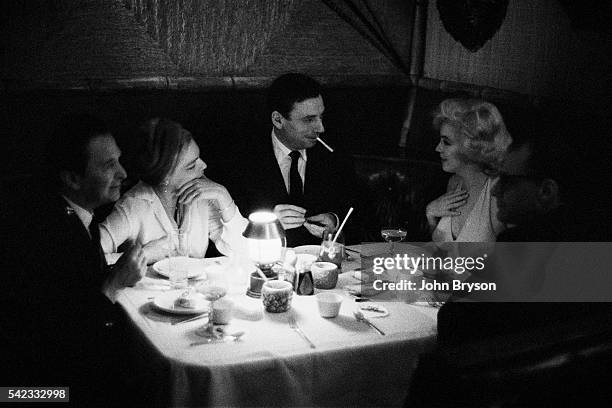 American director George Cukor, French actress Simone Signoret, Italian-born French actor and singer Yves Montand, American actress, singer, and...