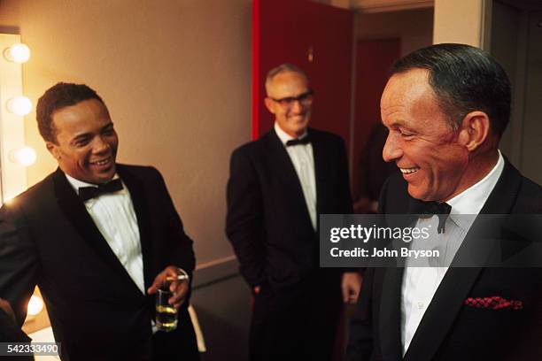 American music conductor, record producer, film composer and trumpeter Quincy Jones and singer and actor Frank Sinatra in Sinatra's dressing room.