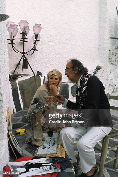 Spanish Catalan surrealist painter, sculptor, and screenwriter Salvador Dali with his muse, French singer Amanda Lear, at his home in Port Lligat.
