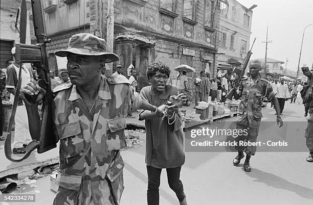 Woman accused of being a rebel is arrested by the Nigerian army from ECOWAS. She will be badly beaten for hours to force her confession.