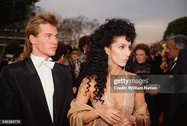 American actors Cher and Val Kilmer arrive at the 56th Academy Awards, where Cher is nominated for Best Supporting Actress in Silkwood.