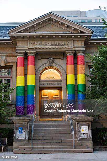 Pride Rainbow Flag in columns of Toronto Public Library in Yorktown Village. The library is located on a heritage building.