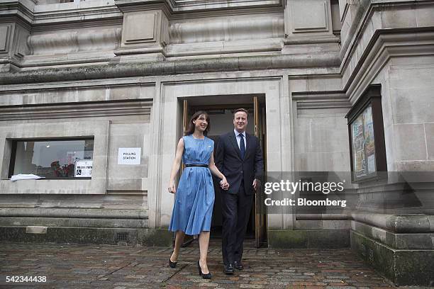 David Cameron, U.K. Prime minister and leader of the Conservative Party, right, and his wife Samantha Cameron, depart a polling station after casting...