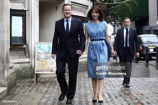 David Cameron, U.K. Prime minister and leader of the Conservative Party, left, and his wife Samantha Cameron, depart after casting their votes in the...