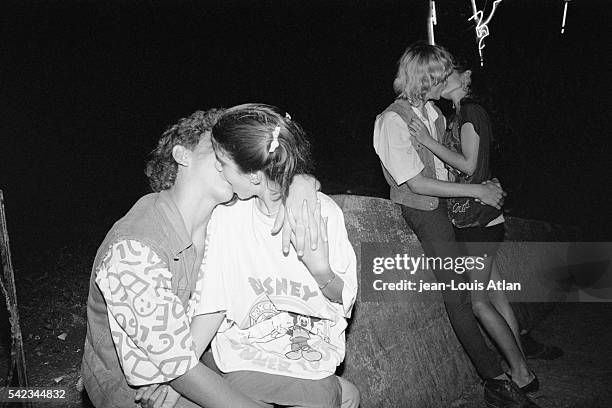 Young couples celebrate the 30th anniversary of the Cuban revolution with a kiss in Havana.