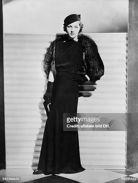 Martha Sleeper wearing an evening gown and a silver fox stole. 1933