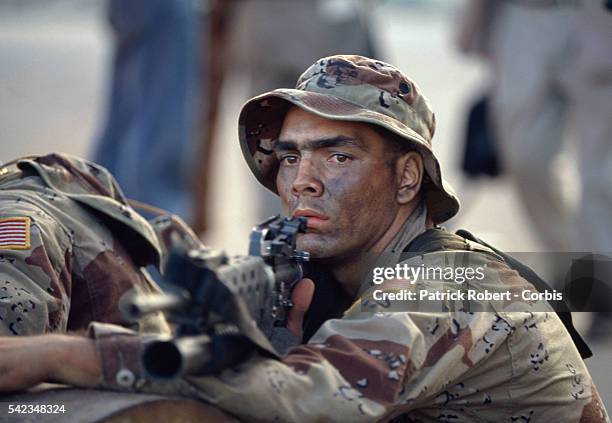 Marine aims his weapon, ready for combat in Mogadishu, though the troops face no initial resistance after landing in Somalia. The US Army launched...