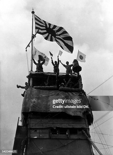 NThe Japanese flag flies above the newly constructed military headquarters in Shanghai following the Japanese capture of the city, November 1937.