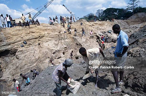 Employees working in a diamond mine. | Location: Kiodu, Sierra Leone.